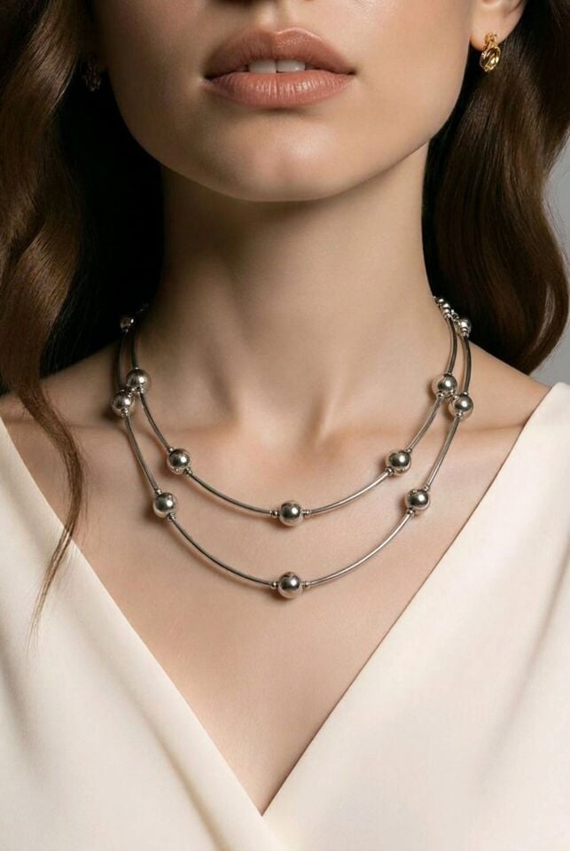 GÜMÜŞ RENGİNDE ÜZERİNDE TOP DETAYLARIN OLDUĞU ÇELİK KOLYE